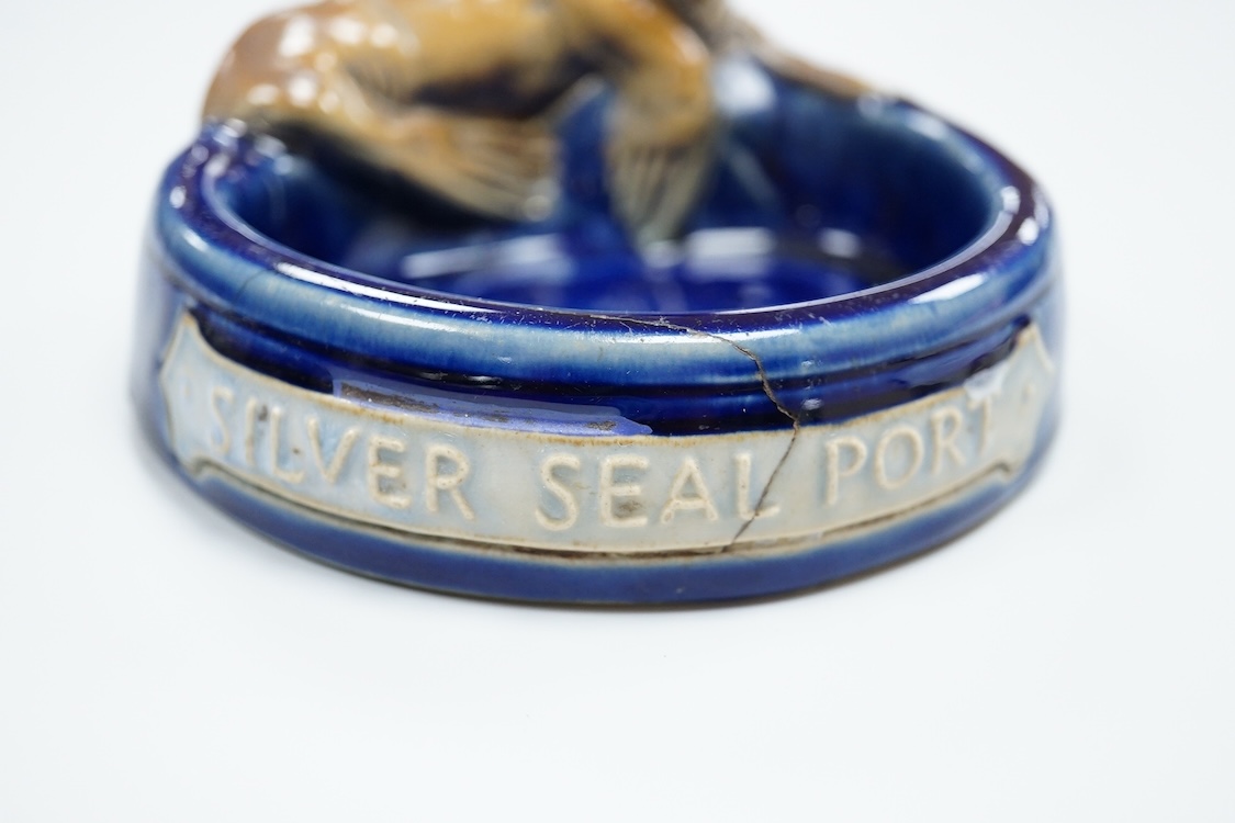 A Doulton ‘silver seal port’ advertising ashtray, 13cm wide (a.f)